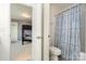 Bathroom and view into a bedroom with blue walls and a bunk bed at 15131 Oleander Dr, Charlotte, NC 28278