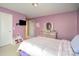 A cozy bedroom featuring purple walls, a plush bed and a wall mounted television at 15131 Oleander Dr, Charlotte, NC 28278