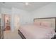 Comfortable bedroom with white walls, plush bed, and connecting ensuite bathroom at 15131 Oleander Dr, Charlotte, NC 28278