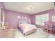 A purple bedroom featuring a queen bed, side table, window, and small doll house at 15131 Oleander Dr, Charlotte, NC 28278