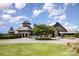 Elegant clubhouse with stone facade, tower, mature landscaping, and circular drive offers luxury amenities at 15131 Oleander Dr, Charlotte, NC 28278