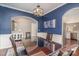 Elegant dining room with navy walls, chandelier, and hardwood floors, open to kitchen at 15131 Oleander Dr, Charlotte, NC 28278