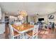 Open dining area with wood table & pendant lighting, flowing into living room and kitchen at 15131 Oleander Dr, Charlotte, NC 28278