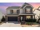 Charming two-story home with brick and siding exterior, landscaped front yard, and attached two-car garage at 15131 Oleander Dr, Charlotte, NC 28278
