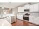 Well-equipped kitchen featuring white cabinets, stainless steel appliances, and ample counter space at 15131 Oleander Dr, Charlotte, NC 28278