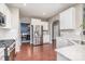 Modern kitchen featuring stainless steel appliances, white cabinetry, and a dining area at 15131 Oleander Dr, Charlotte, NC 28278