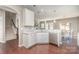 Bright kitchen with white cabinets, stainless appliances and a view to the dining area at 15131 Oleander Dr, Charlotte, NC 28278