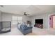 Inviting living room featuring a comfortable blue couch and a ceiling fan for added comfort at 15131 Oleander Dr, Charlotte, NC 28278