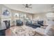 Comfortable living room with fireplace, ceiling fan, and sofa near the dining area at 15131 Oleander Dr, Charlotte, NC 28278