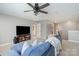 Well-lit living room with a modern ceiling fan and television at 15131 Oleander Dr, Charlotte, NC 28278