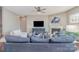 A spacious living room features a fireplace, flat screen TV and a comfortable blue sofa at 15131 Oleander Dr, Charlotte, NC 28278