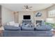 Bright open-concept living room with hardwood floors, ceiling fan, and plenty of comfortable seating at 15131 Oleander Dr, Charlotte, NC 28278