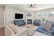Cozy living room featuring a fireplace, ceiling fan, large TV, and comfortable seating at 15131 Oleander Dr, Charlotte, NC 28278