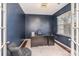 Private office with french doors, a large window, dark blue walls, and a stylish area rug at 15131 Oleander Dr, Charlotte, NC 28278