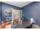 Home office with dark blue accent wall, shelving and space for productivity at 15131 Oleander Dr, Charlotte, NC 28278