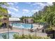Large community pool featuring a sundeck, lounge chairs, umbrellas, and a building at 15131 Oleander Dr, Charlotte, NC 28278