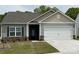 Charming one-story home featuring a two-car garage, stone accents, and well-maintained lawn at 1578 Doran Ter, Richburg, SC 29729