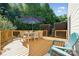 Inviting wooden deck featuring an umbrella-shaded dining set, perfect for outdoor gatherings and relaxation at 1622 Candlewood Ridge Ln, Matthews, NC 28105