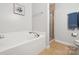 Bright bathroom featuring a large soaking tub and glass enclosed shower at 1622 Candlewood Ridge Ln, Matthews, NC 28105
