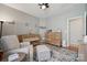 Stylish Bedroom with crib, dresser and a comfortable chair with ottoman at 1622 Candlewood Ridge Ln, Matthews, NC 28105