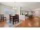 Bright dining area featuring hardwood floors, an open view to the living room, and plenty of natural light at 1622 Candlewood Ridge Ln, Matthews, NC 28105