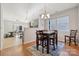 Open dining area with hardwood floors, a stylish chandelier, and plenty of natural light at 1622 Candlewood Ridge Ln, Matthews, NC 28105