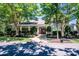 Charming community clubhouse with a welcoming red door, surrounded by lush landscaping and mature trees at 17307 Villanova Rd, Huntersville, NC 28078