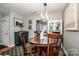 Elegant dining room featuring a modern chandelier, hardwood floors, and stylish decor at 17307 Villanova Rd, Huntersville, NC 28078