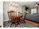 Cozy dining area with a stylish chandelier, wooden table, and seamless flow into the living room at 17307 Villanova Rd, Huntersville, NC 28078