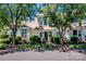 Inviting two-story townhome with manicured lawn and mature trees on a sunny day at 17307 Villanova Rd, Huntersville, NC 28078
