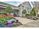 Charming gray home with a welcoming front entrance and colorful flowers at 17307 Villanova Rd, Huntersville, NC 28078
