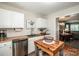 Well-appointed kitchen featuring white cabinets, butcher block countertops, and stainless steel appliances at 17307 Villanova Rd, Huntersville, NC 28078