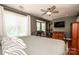 A cozy bedroom with a comfortable bed, natural light, and a ceiling fan at 17307 Villanova Rd, Huntersville, NC 28078