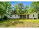 View of home's rear exterior showing the screened-in porch and ample backyard space at 1917 Tom Sadler Rd, Charlotte, NC 28214