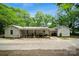 A sprawling backyard featuring a covered porch and lots of trees at 1917 Tom Sadler Rd, Charlotte, NC 28214