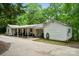 A sprawling backyard featuring a covered porch and lots of trees at 1917 Tom Sadler Rd, Charlotte, NC 28214