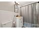 This bathroom features a pedestal sink and shower with a curtain at 1917 Tom Sadler Rd, Charlotte, NC 28214