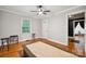 Bright bedroom with hardwood floors, a ceiling fan, two windows, and gray walls for a minimalist design at 1917 Tom Sadler Rd, Charlotte, NC 28214