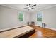 Bright bedroom featuring a ceiling fan, and two windows with natural light and hardwood flooring at 1917 Tom Sadler Rd, Charlotte, NC 28214