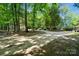 Long private driveway leading to a charming home, set amidst lush greenery and mature trees at 1917 Tom Sadler Rd, Charlotte, NC 28214