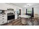 Kitchen featuring stainless steel appliances, a marble-topped dining table, and white cabinetry at 1917 Tom Sadler Rd, Charlotte, NC 28214