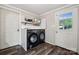 Efficient laundry room with modern washer and dryer, storage shelf, and a window offering natural light at 1917 Tom Sadler Rd, Charlotte, NC 28214