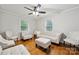 Cozy living room features hardwood flooring, a ceiling fan, and modern white sofas for comfortable lounging at 1917 Tom Sadler Rd, Charlotte, NC 28214