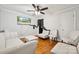 Bright living room features hardwood floors, a ceiling fan, and modern white sofas for a comfortable, inviting space at 1917 Tom Sadler Rd, Charlotte, NC 28214