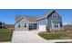 Charming, newly constructed blue home featuring stone accents, a paved driveway, and manicured front lawn at 1945 Hendricks St, Rock Hill, SC 29732