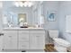 Bright bathroom featuring granite countertops, double sinks, and a large mirror at 210 Dorothy Dr, China Grove, NC 28023