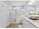 Bright bathroom featuring granite countertops, double sinks, and a glass enclosed shower at 210 Dorothy Dr, China Grove, NC 28023