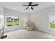 Cozy bedroom with a comfortable armchair, two windows with natural light, and neutral carpeting at 210 Dorothy Dr, China Grove, NC 28023