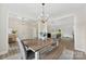 Open-concept dining area featuring modern chandelier and views of living spaces at 210 Dorothy Dr, China Grove, NC 28023