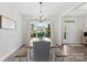 Cozy dining room with bench seating, wood table, chandelier, and large windows at 210 Dorothy Dr, China Grove, NC 28023
